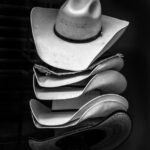 grayscale photography of piled cowboy hats