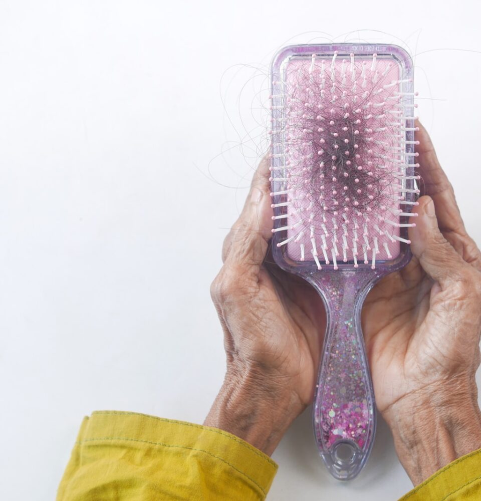 a person holding a hair brush in their hands